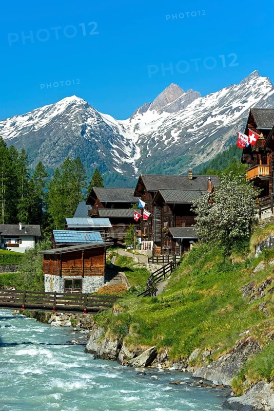 Listed townscape with Swiss chalet houses in front of Valais Alps