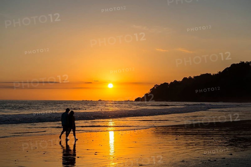 Man and woman strolling on the beach