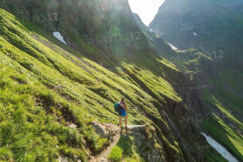 Hiker on a trail in the sunshine