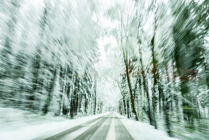 Snow-covered road in snow-covered forest