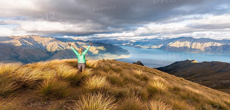 Female hiker stretching arms in the air