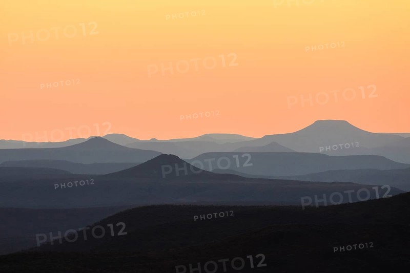 Staggered mountains at sunset