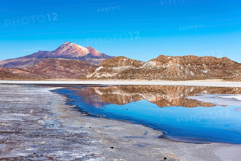 Volcano Cerro Tunupa with reflection in the Salar de Uyuni