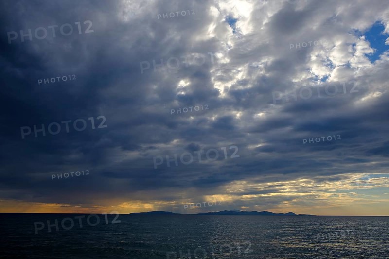 Thunderclouds at sunset on the beach