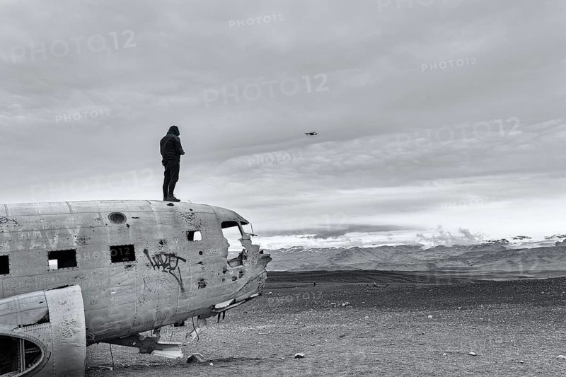 Man on aircraft wreck Douglas DC-3 controls Drone