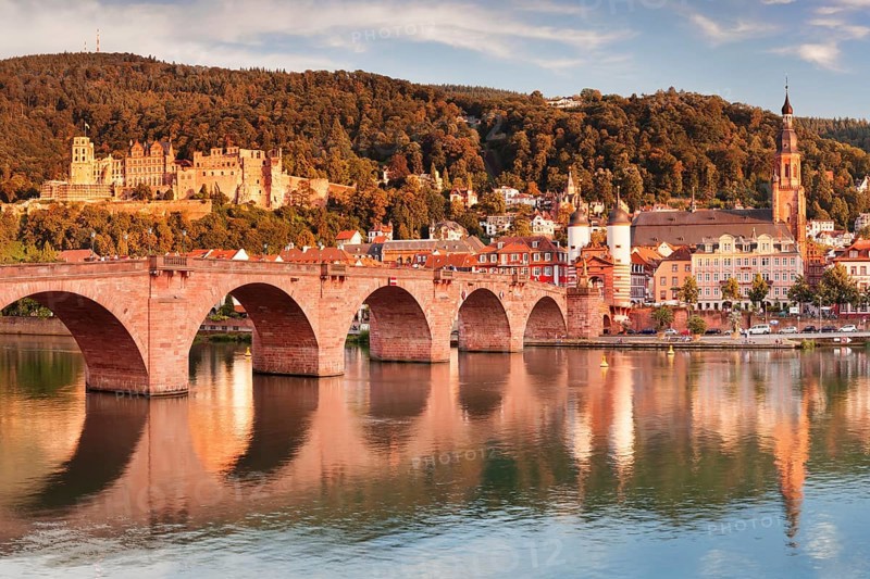 View of Karl Theodor Bridge and Gate over the Neckar River with castle in Heidelberg