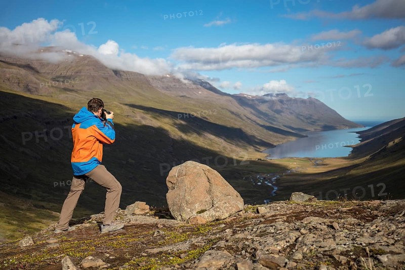Photographer photographs view from Mjoafjaroarheioi Pass onto Mjoifjorour Fjord