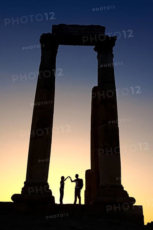 Couple forms a heart in sunset at the Temple of Hercules at the Citadel