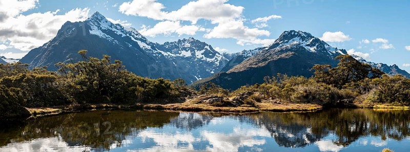 Small mountain lake with reflection of the mountain chain
