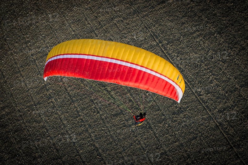 Paraglider over ploughed field