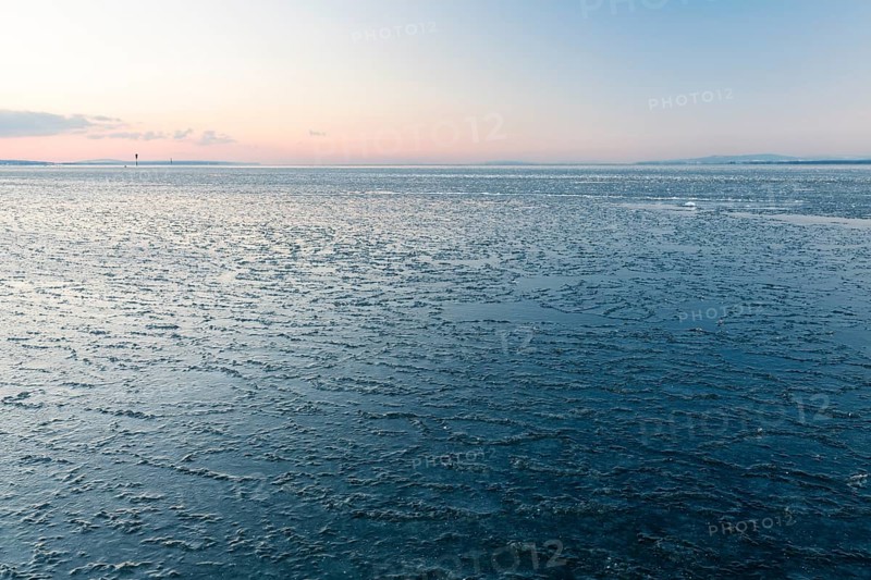 Ice on the shore of Lake Constance on a winter evening
