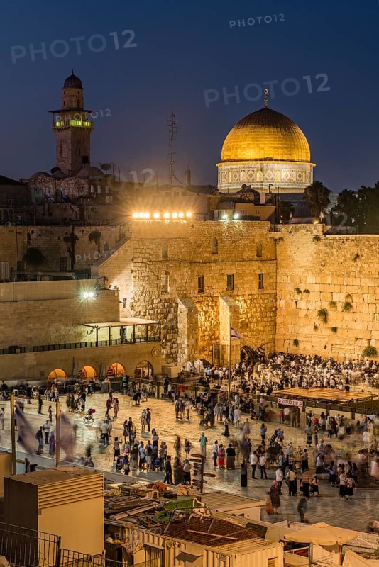 Believers at the Wailing Wall at dusk