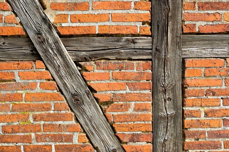 Brick wall with half-timbered beams