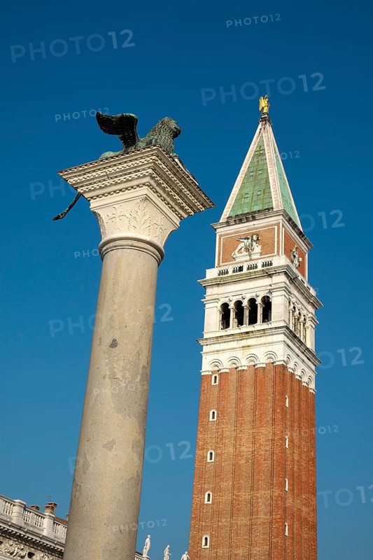 Winged lion on granite column with church tower of Basilica di San Marco