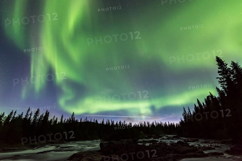 Northern Lights or Aurora Borealis above river Gamajahka or Kamajakka