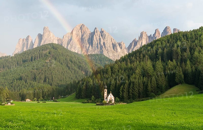 Rainbow in front of the church St. Johann in Ranui