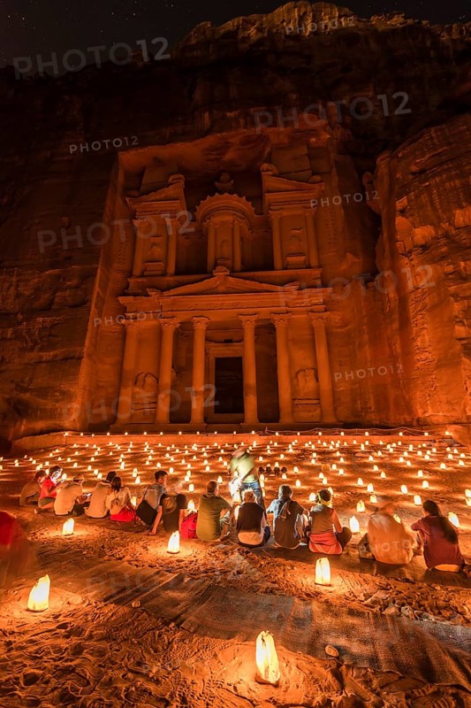 People sitting in front of candles