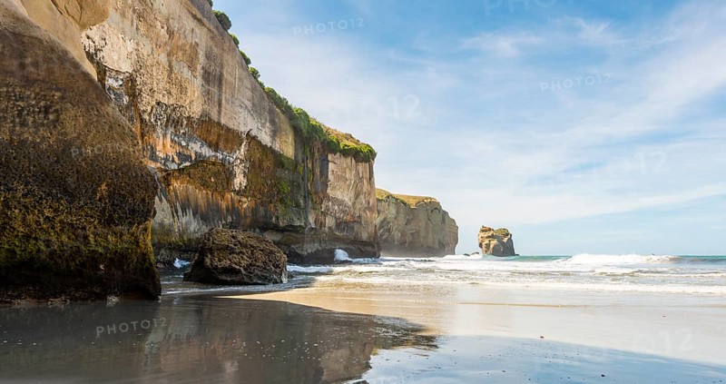 Sandstone rocks towering into the sea