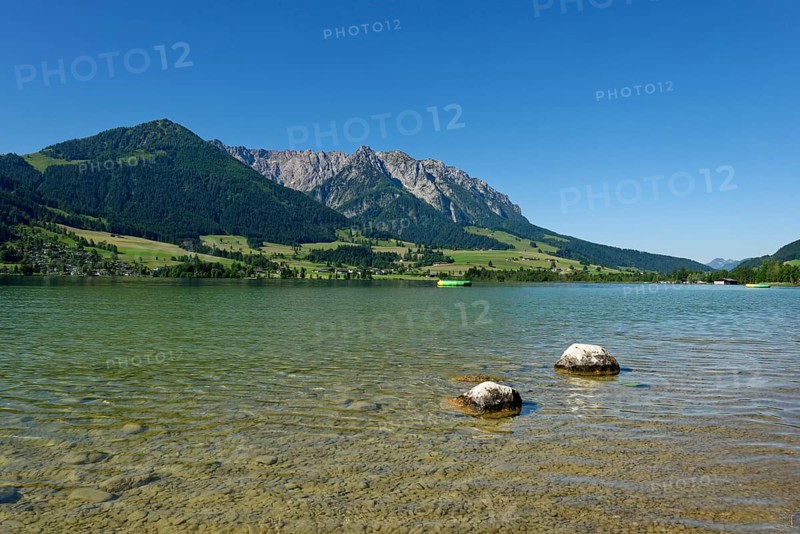 Lake Walchsee in front of mountain range Zahmer Kaiser