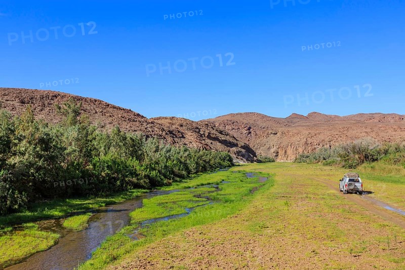 Off-road vehicle drives in the Hoarusib river bed