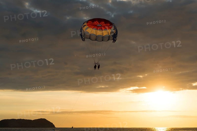 Parasailing at sunset over the sea