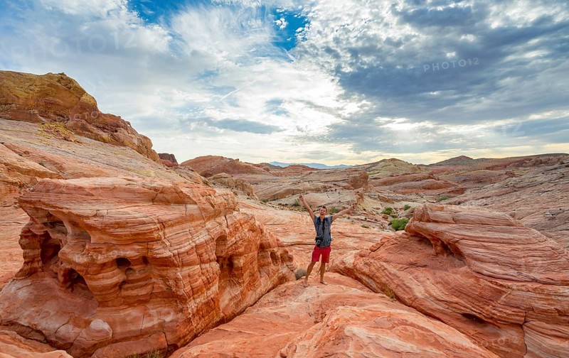 Young man posing with outstretched arms