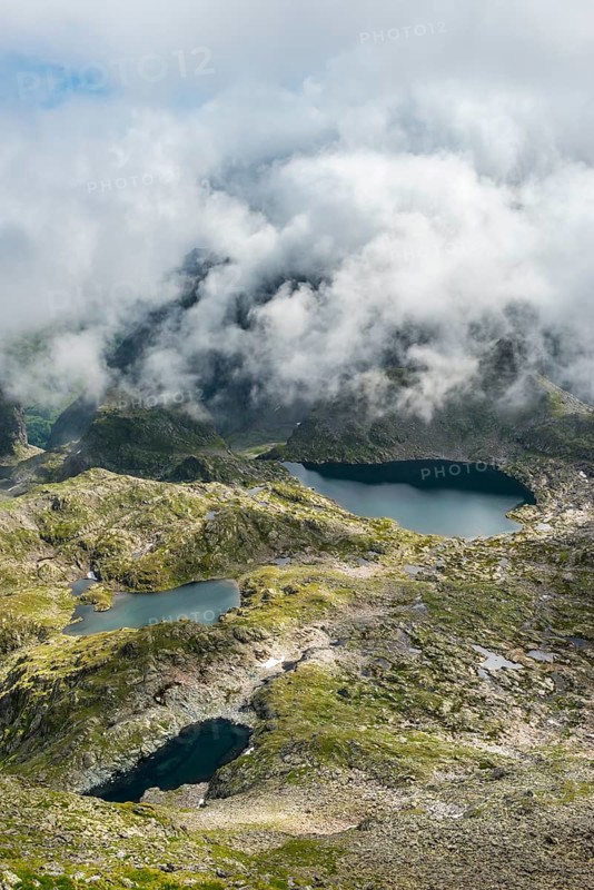 Clouds passing over a ridge with mountain lakes
