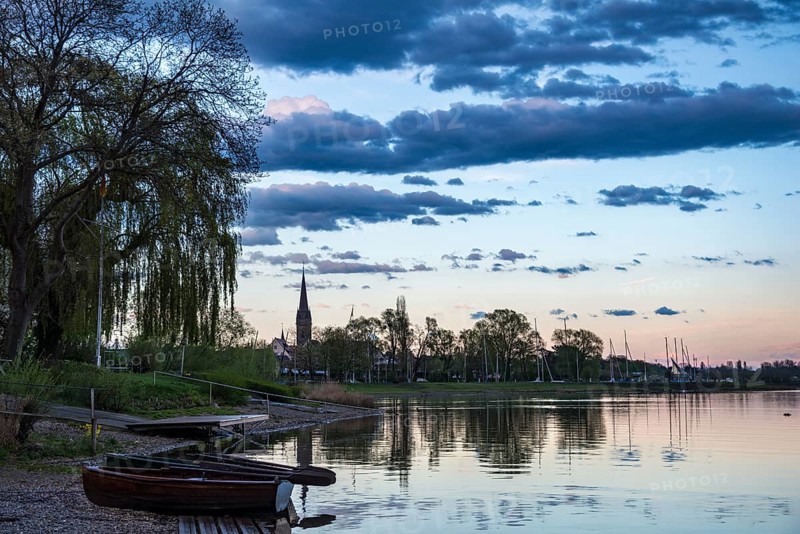 Rowboats by the lake at sunset