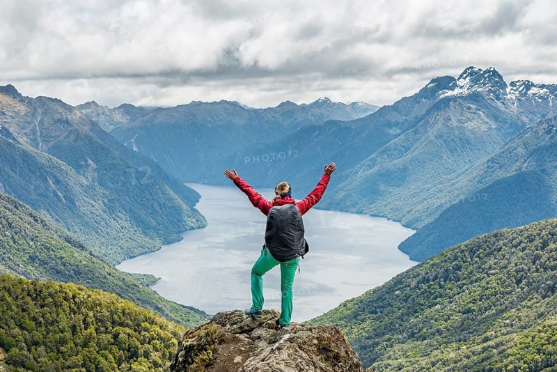 Female hiker is looking at the South Fiord of Lake Te Anau
