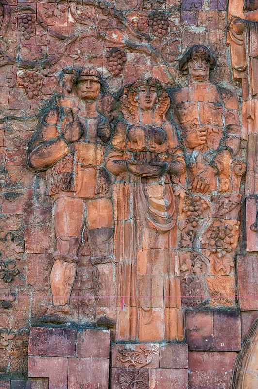 Close-up of figures from communist era on facade of city market