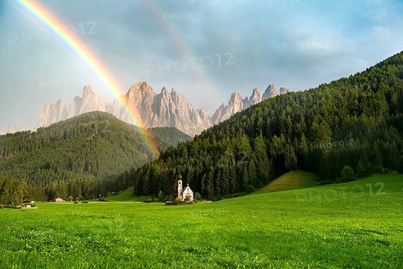 Rainbow in front of the church St. Johann in Ranui