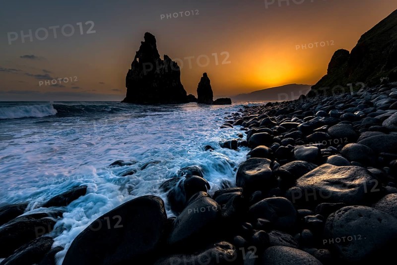 Rock formation Ribeira de Janela at sunrise with black stones at the beach