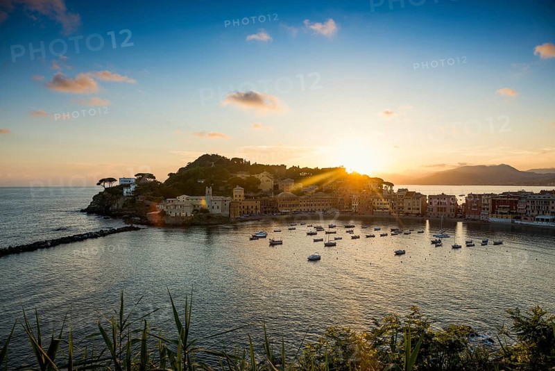 View of the village with harbour in the bay Baia del Silenzio at sunset
