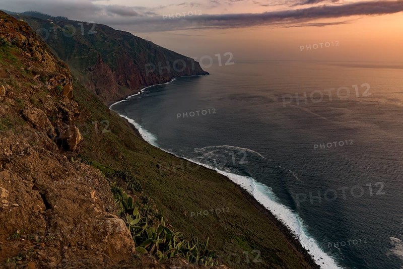 High bank with sea at sunset