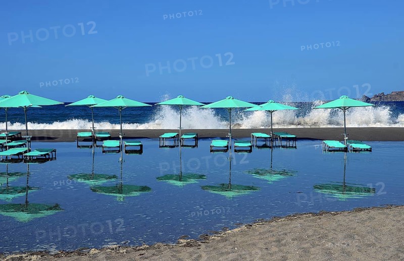 Green umbrellas and sun loungers