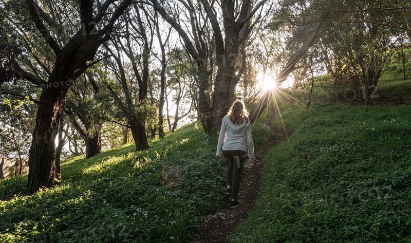 Woman walking on forest path