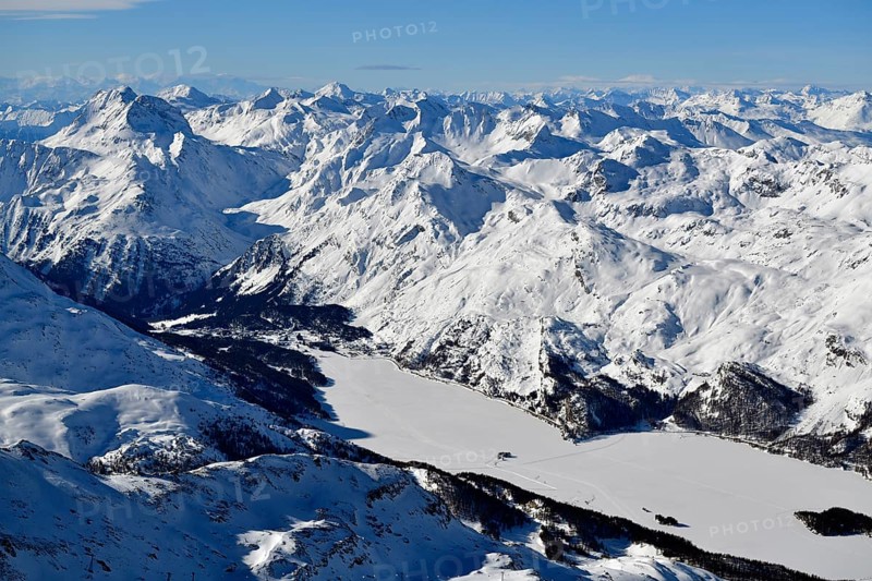 Snow-covered Lake Sils with snow-covered mountains