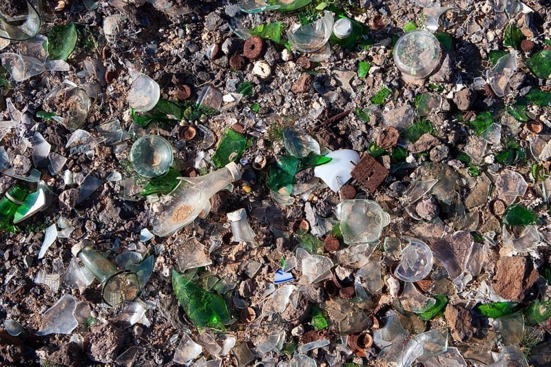 Broken glass and scrap metal at a dump