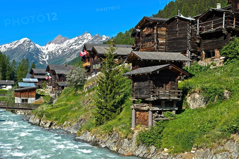 Listed townscape with Swiss chalet houses in front of Valais Alps