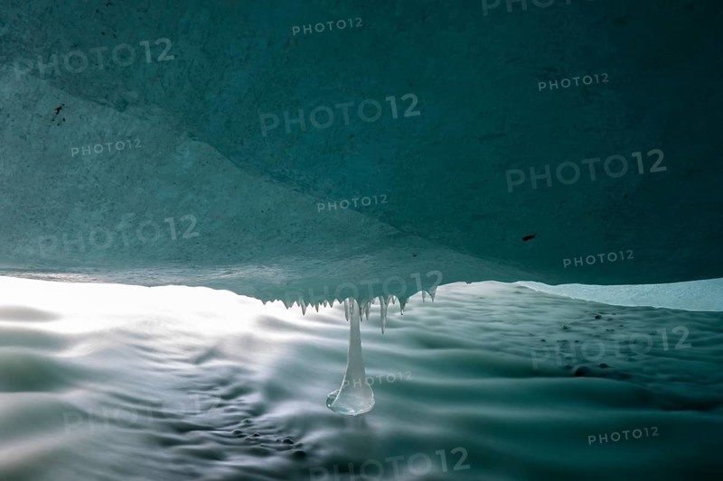 Glacier stream flows under ice cover from Glacier Gate