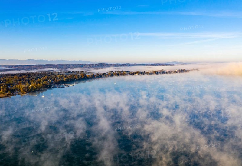 Morning fog over Lake Starnberg with view on Seeshaupt near Munsing