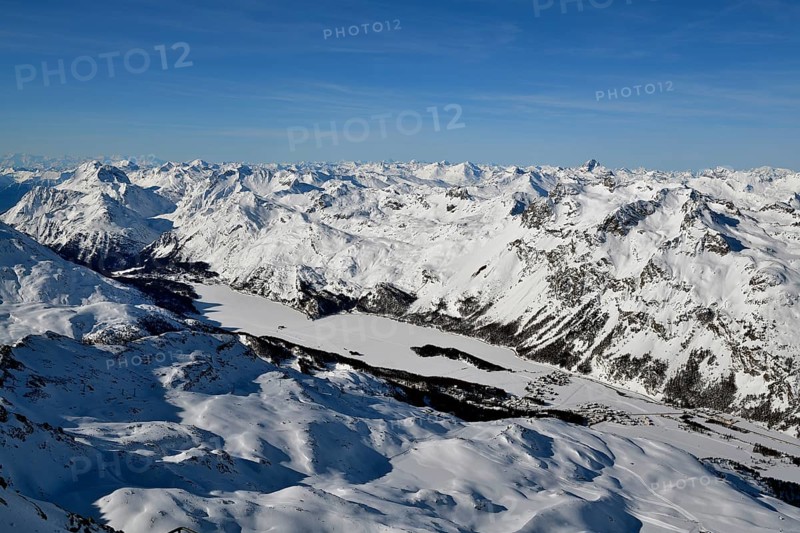Snow-covered Lake Sils with snow-covered mountains