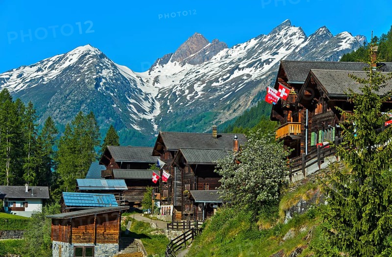 Listed townscape with Swiss chalet houses in front of Valais Alps