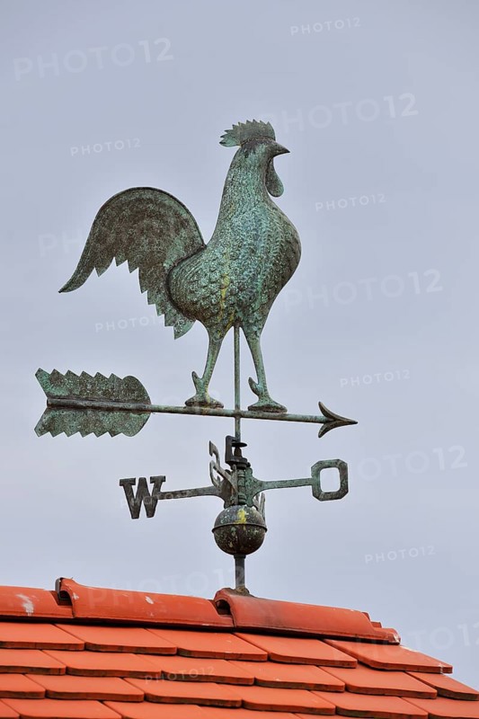 Weathercock with cardinal points on roof