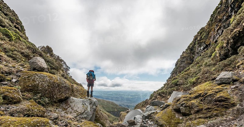 Hiker stands on slope