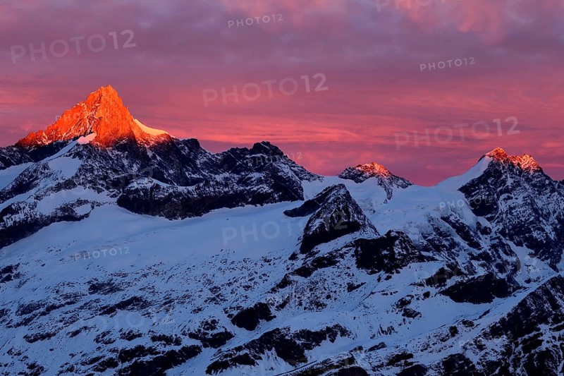 Zinalrothorn with snow in red dawn glow