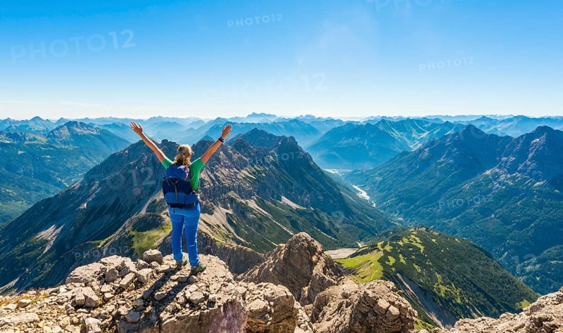 Hiker with views of mountains and Alps