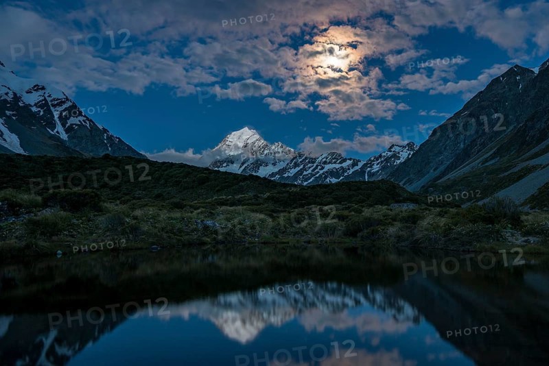 Mount Cook is reflected at moonlight in the pond