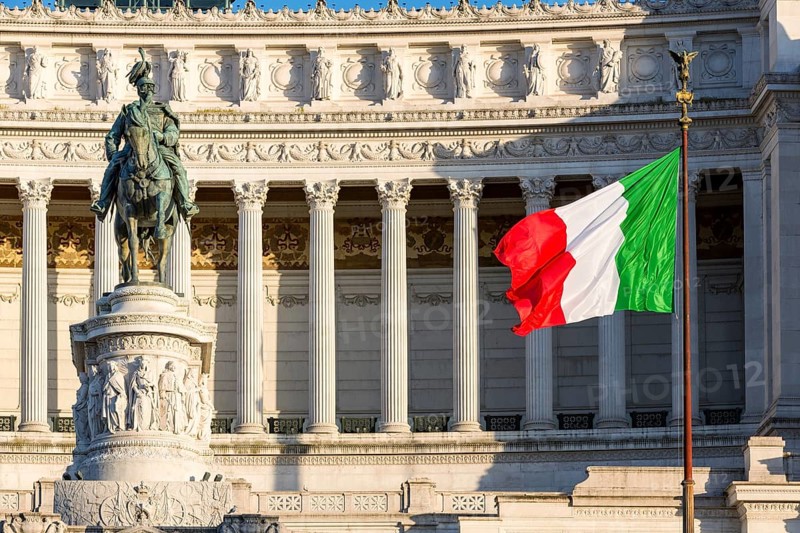 Italian flag drifting in front of Monumento Nazionale a Vittorio Emanuele II