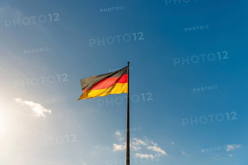 German flag in front of blue sky